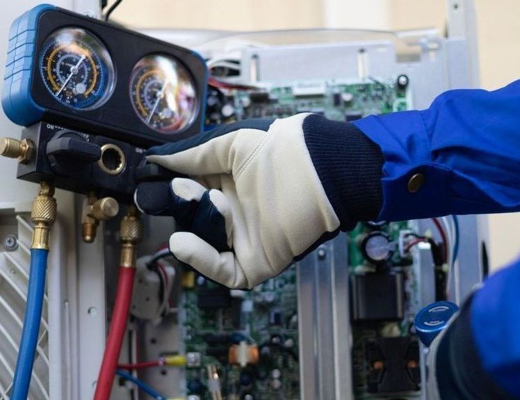 HVAC Specialist Working On A Compressor