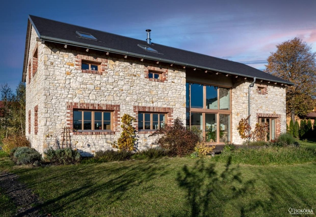 a stone house with a roof that has a skylight
