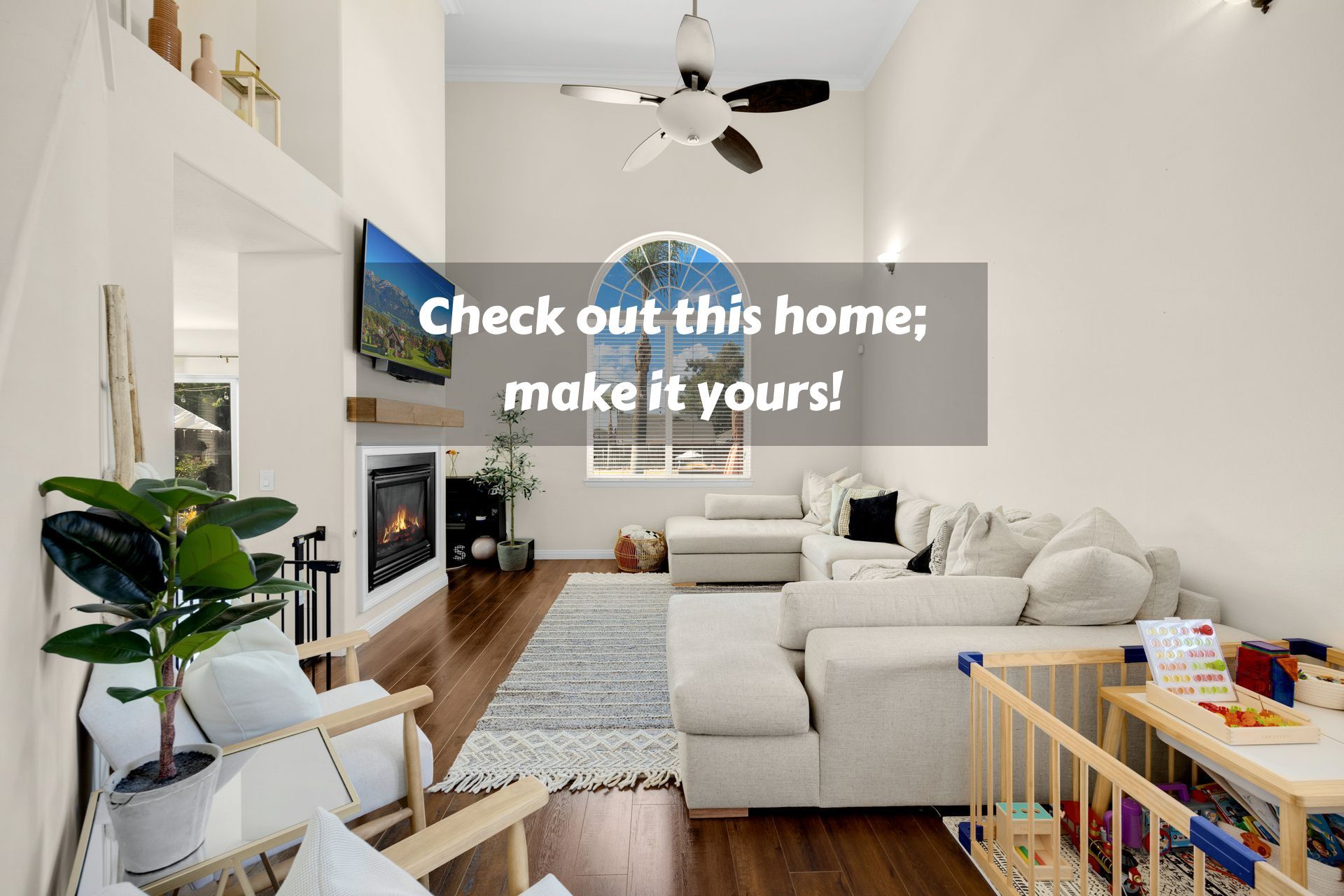Living room with fireplace, TV, and sectional sofa. Natural light, hardwood floors, and text overlay.