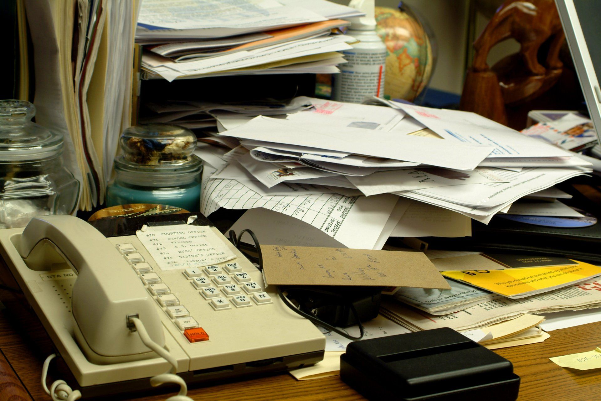 messy cluttered desktop covered in papers