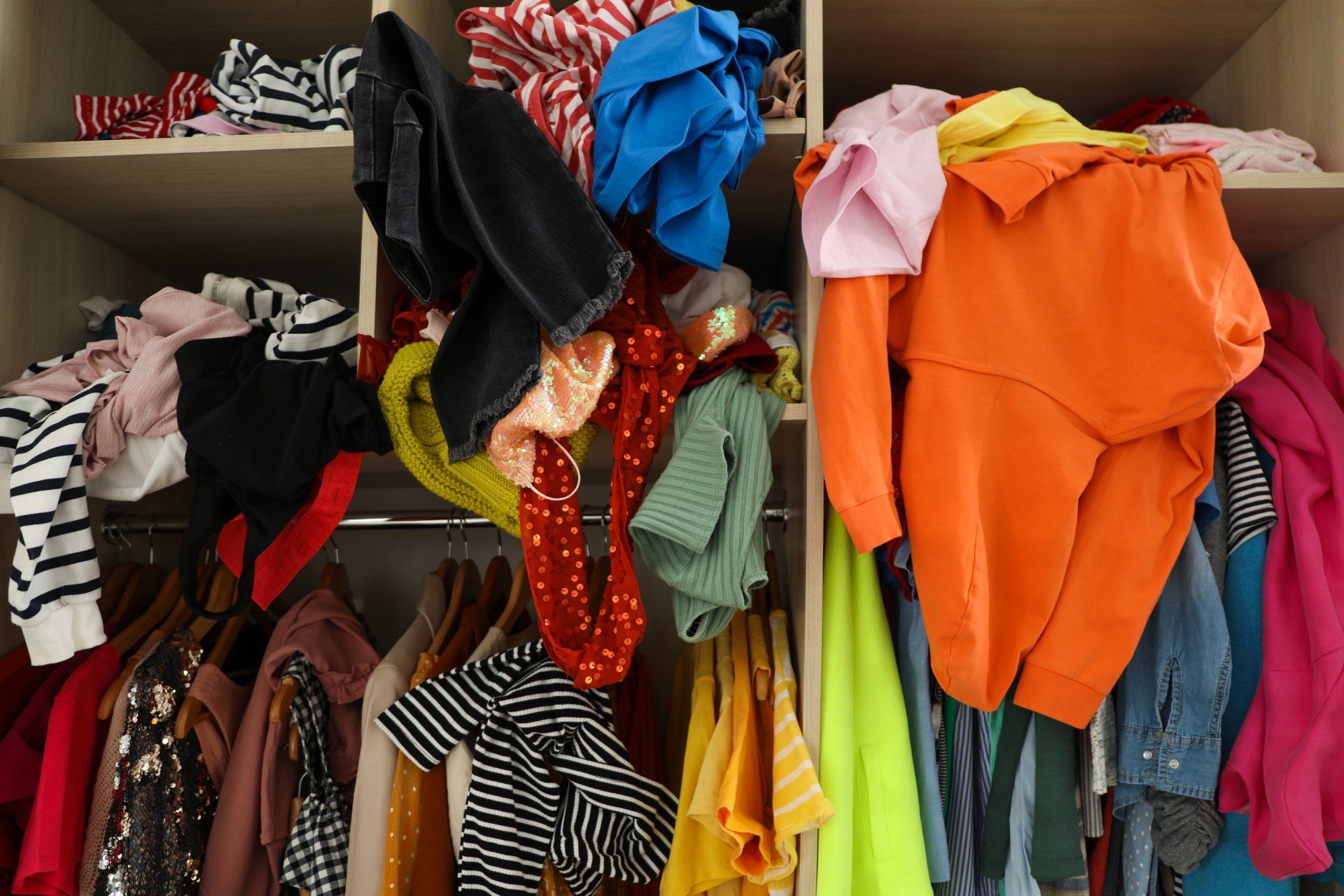 messy pile of clothes in closet