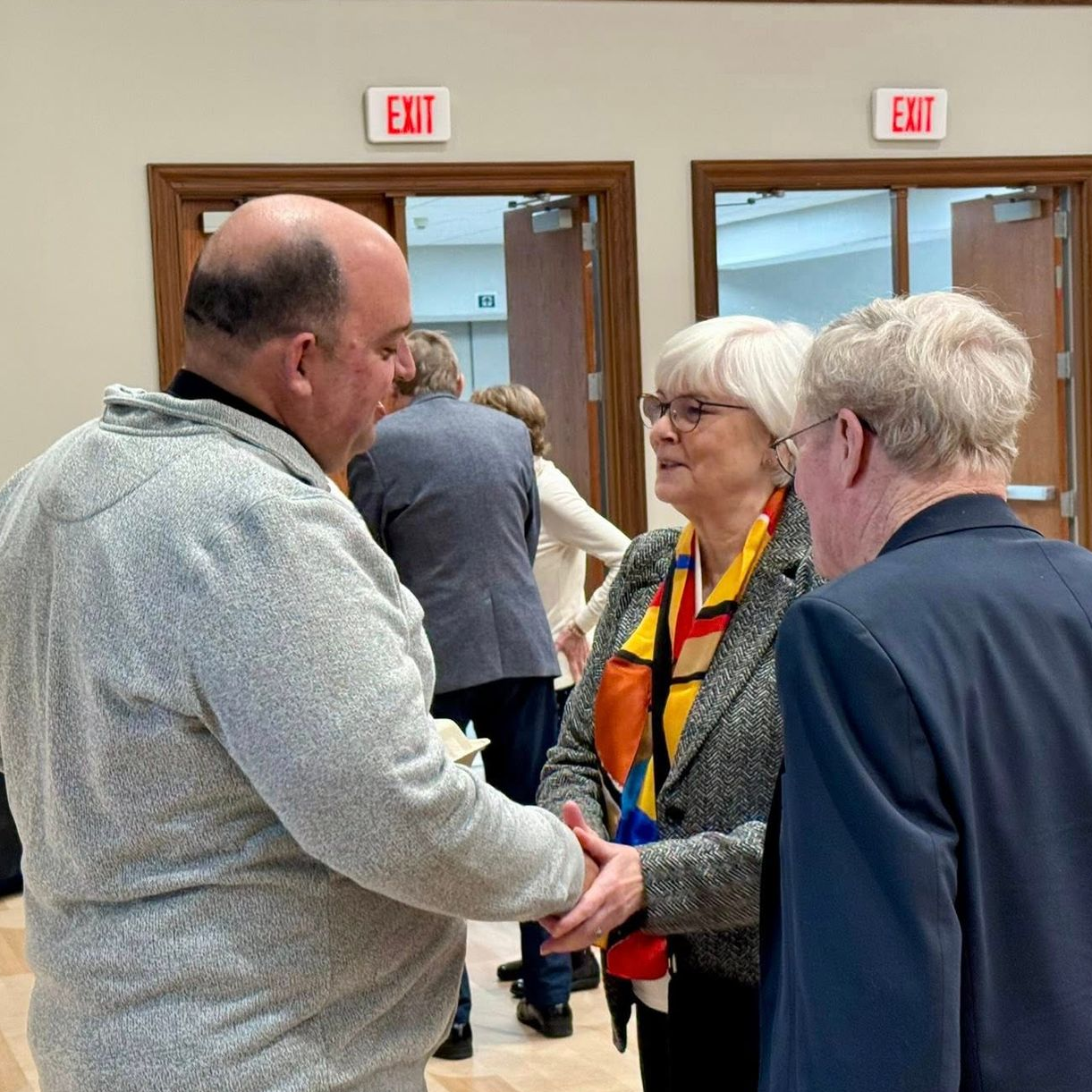 Pastor Paul greeting Terry and Roger.