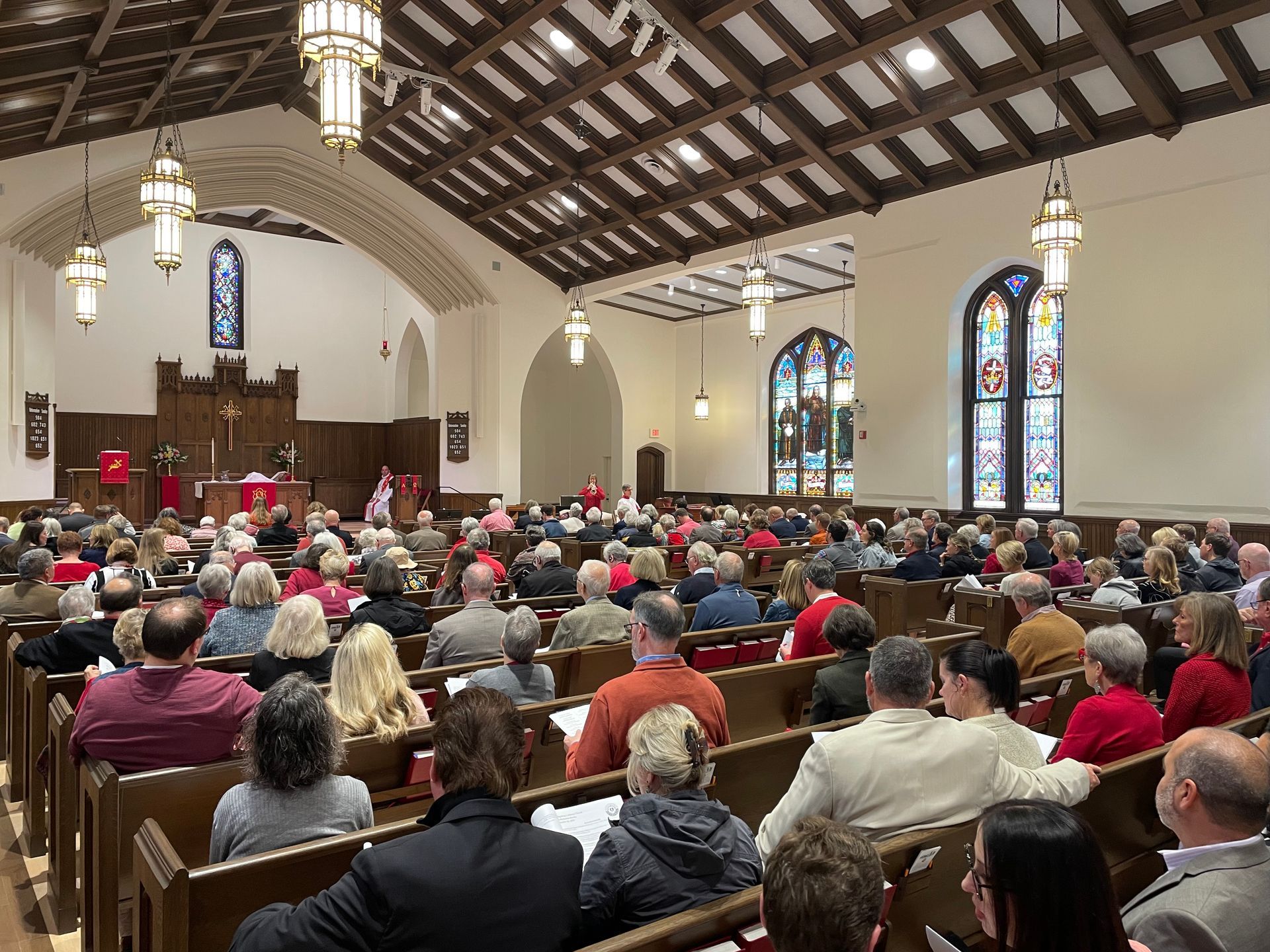 Sanctuary filled with seated worshipers.