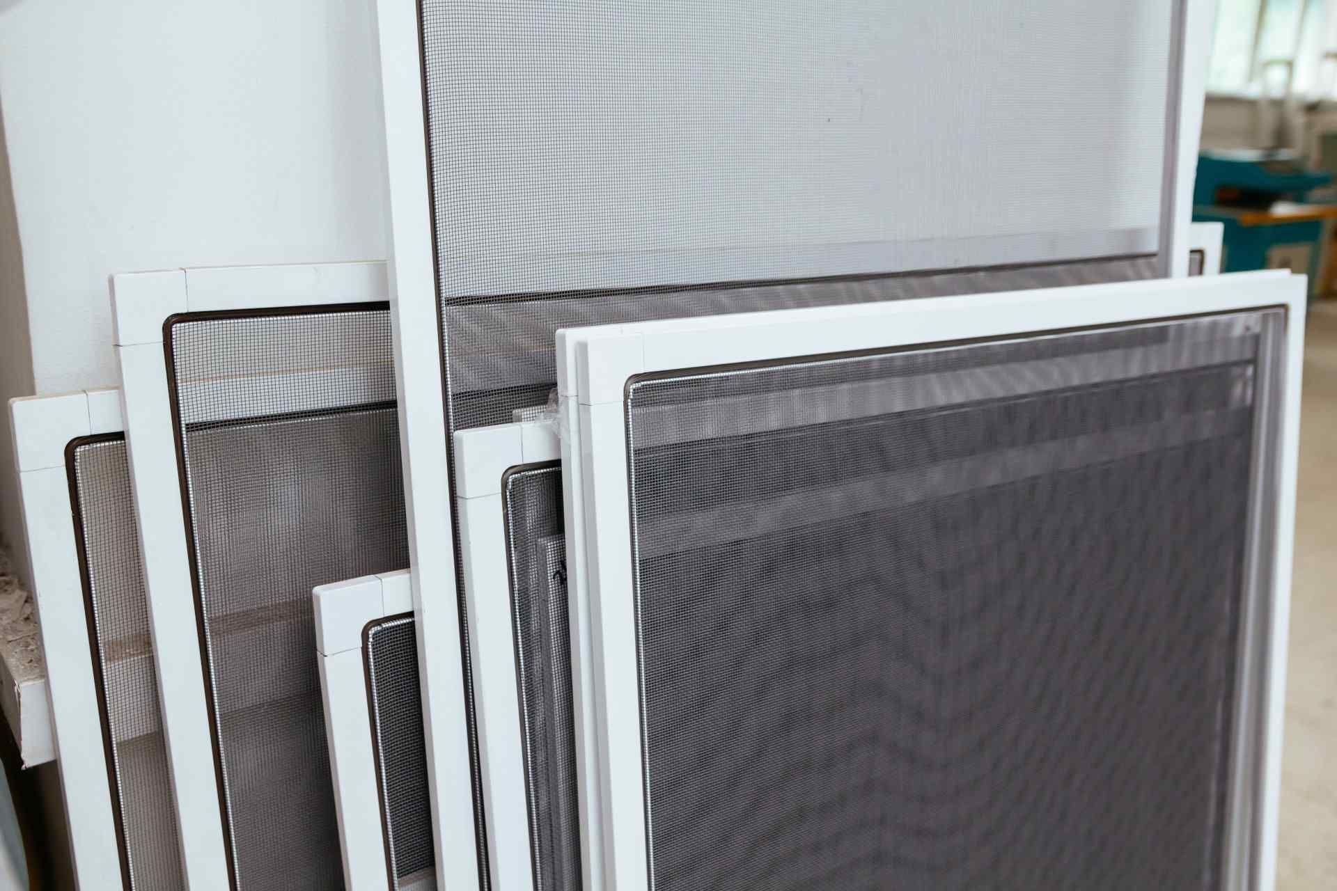 White-framed Window Screens Stacked Together — Big Tom's Security Screens in Farleigh, QLD