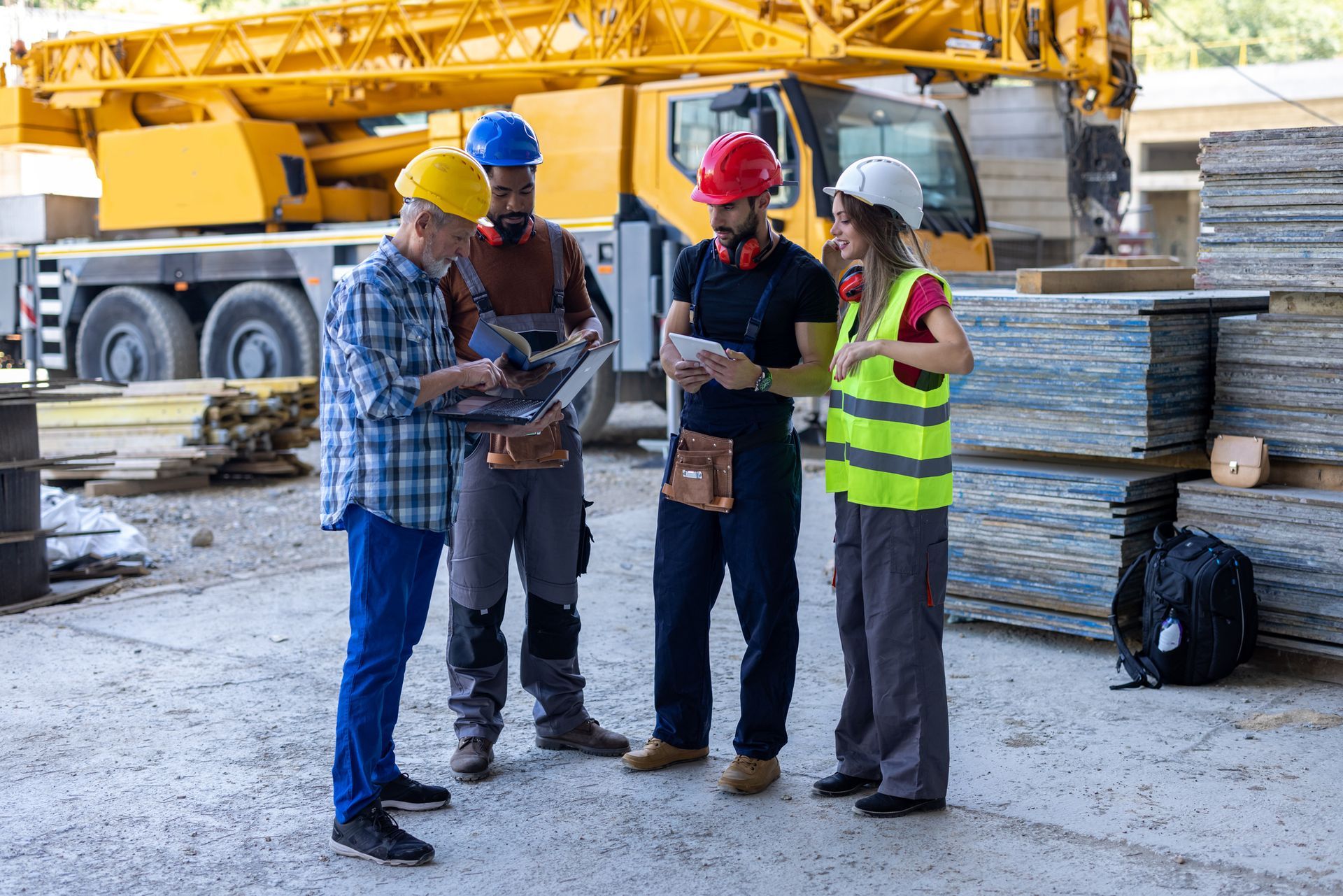 A group of construction workers are standing next to each other on a construction site. A group of construction workers are standing next to each other on a construction site.