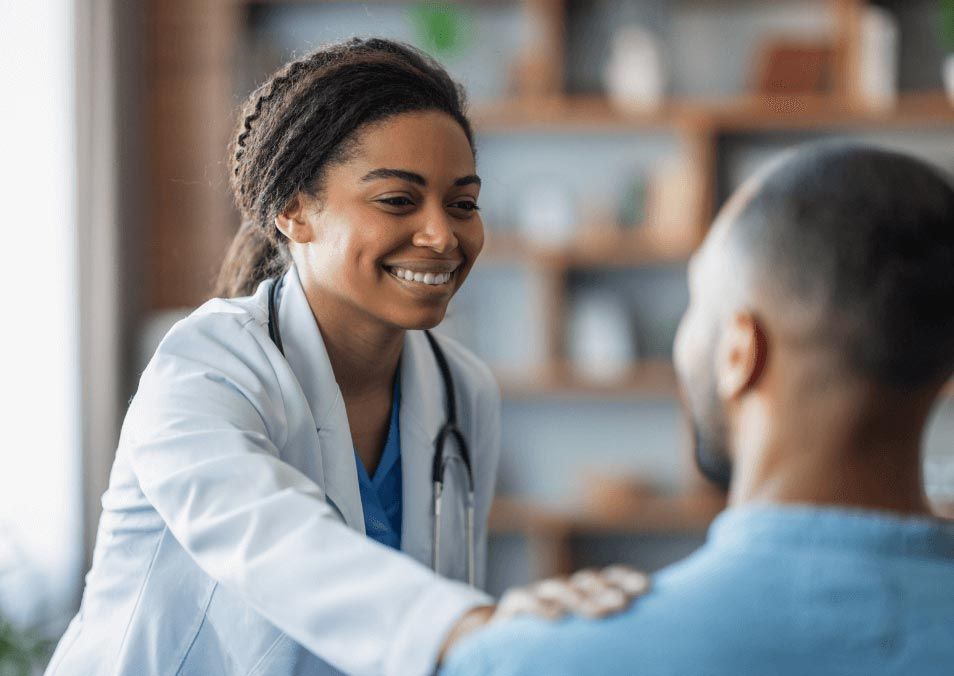 Doctor examining a child while caregiver sits beside them in a clinic