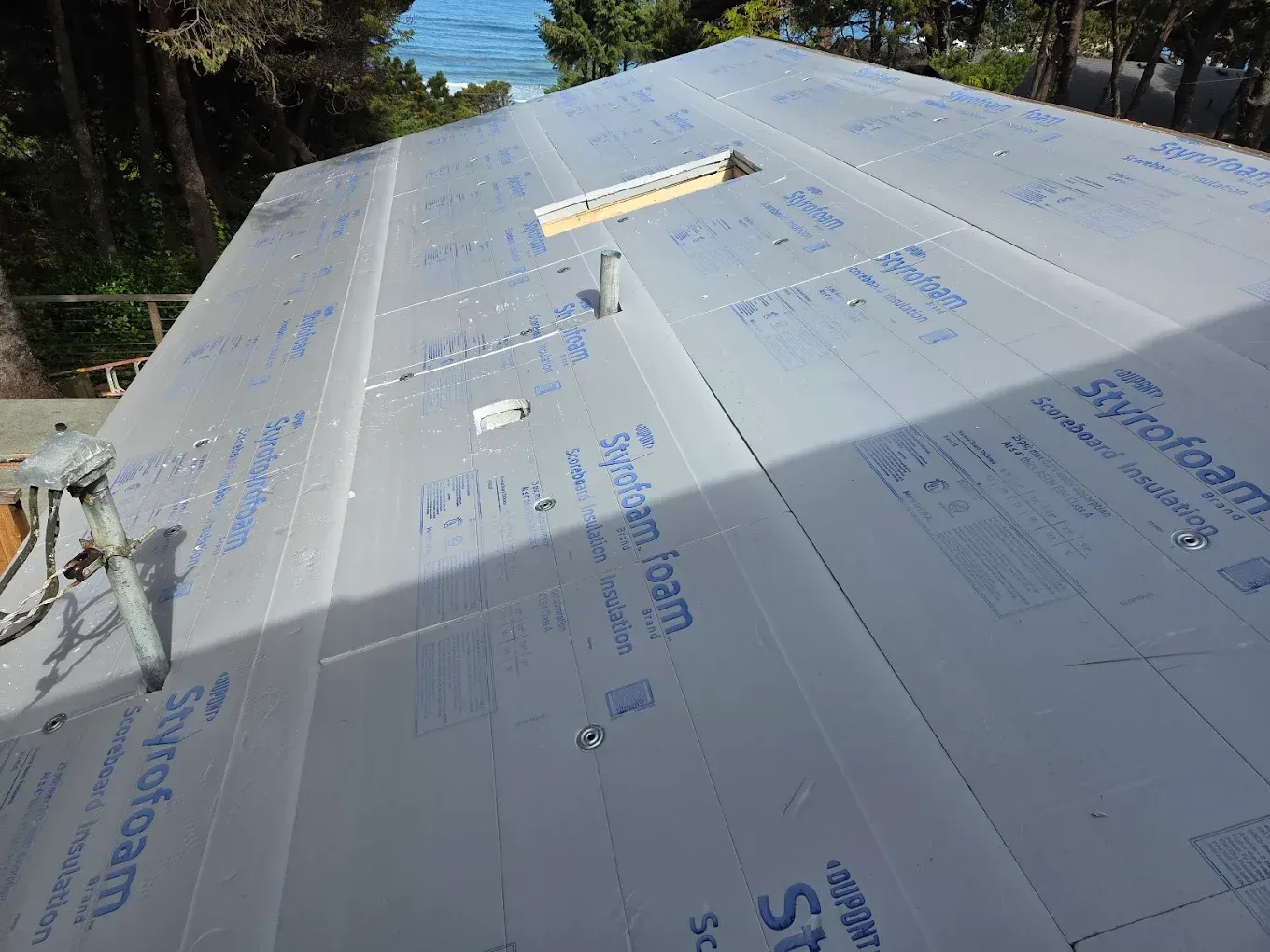 Rooftop covered with styrofoam insulation, with screws securing the panels.