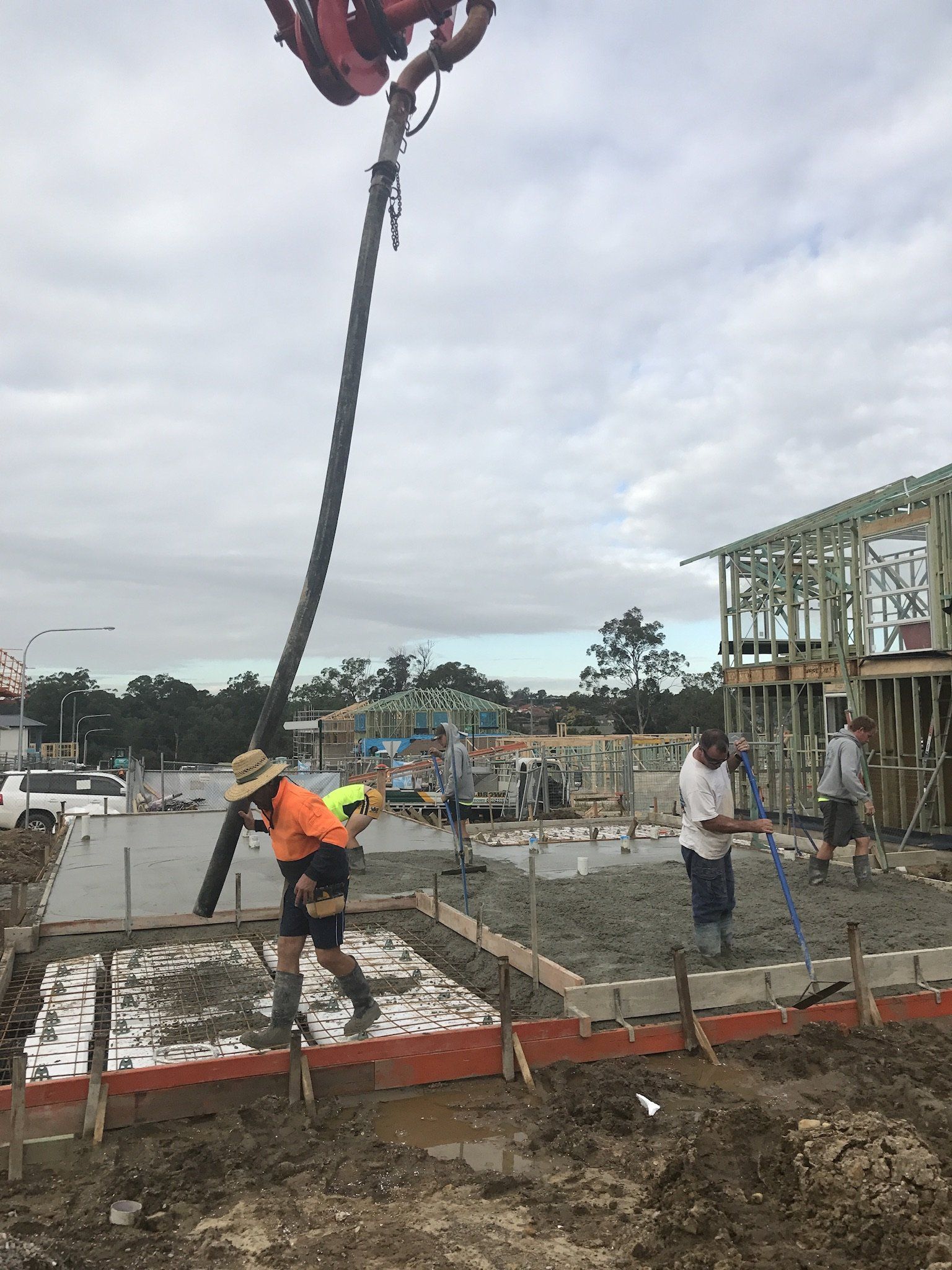 Construction Worker Concrete Pouring During Commercial Concreting Floors - Windsor, NSW - D & M Concrete Services
