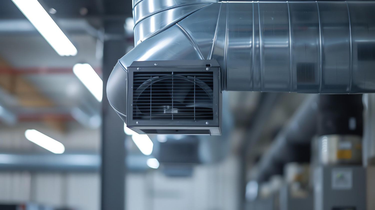 Industrial ventilation duct with a metal air vent in a warehouse ceiling