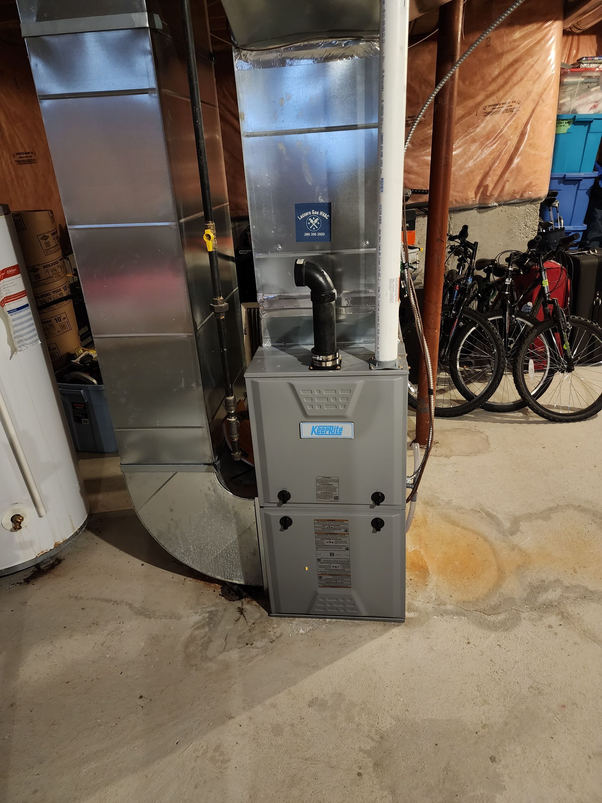 Basement furnace with exposed ductwork and bicycles stored nearby