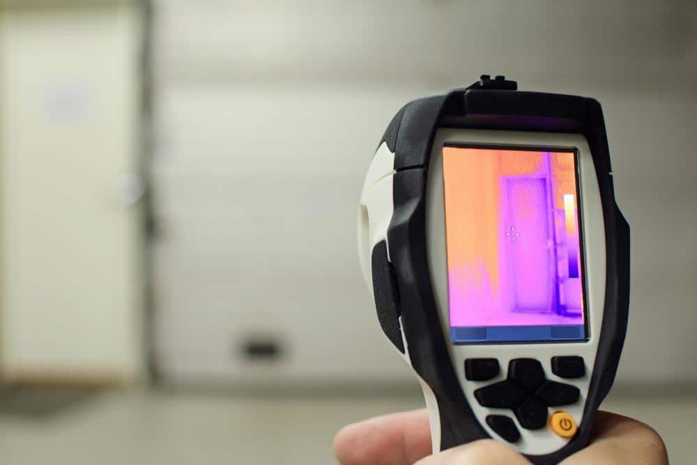 A Person Is Holding A Thermal Camera In Their Hand — Tweed Heads Leak Detection in Casuarina, NSW