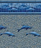 Blue dolphins swimming in a pool of water behind a glass barrier