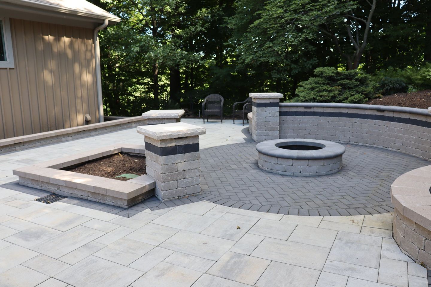 Backyard patio with fire pit and seating area in NWI