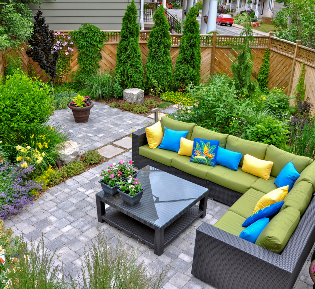 A patio with a sectional couch and a coffee table
