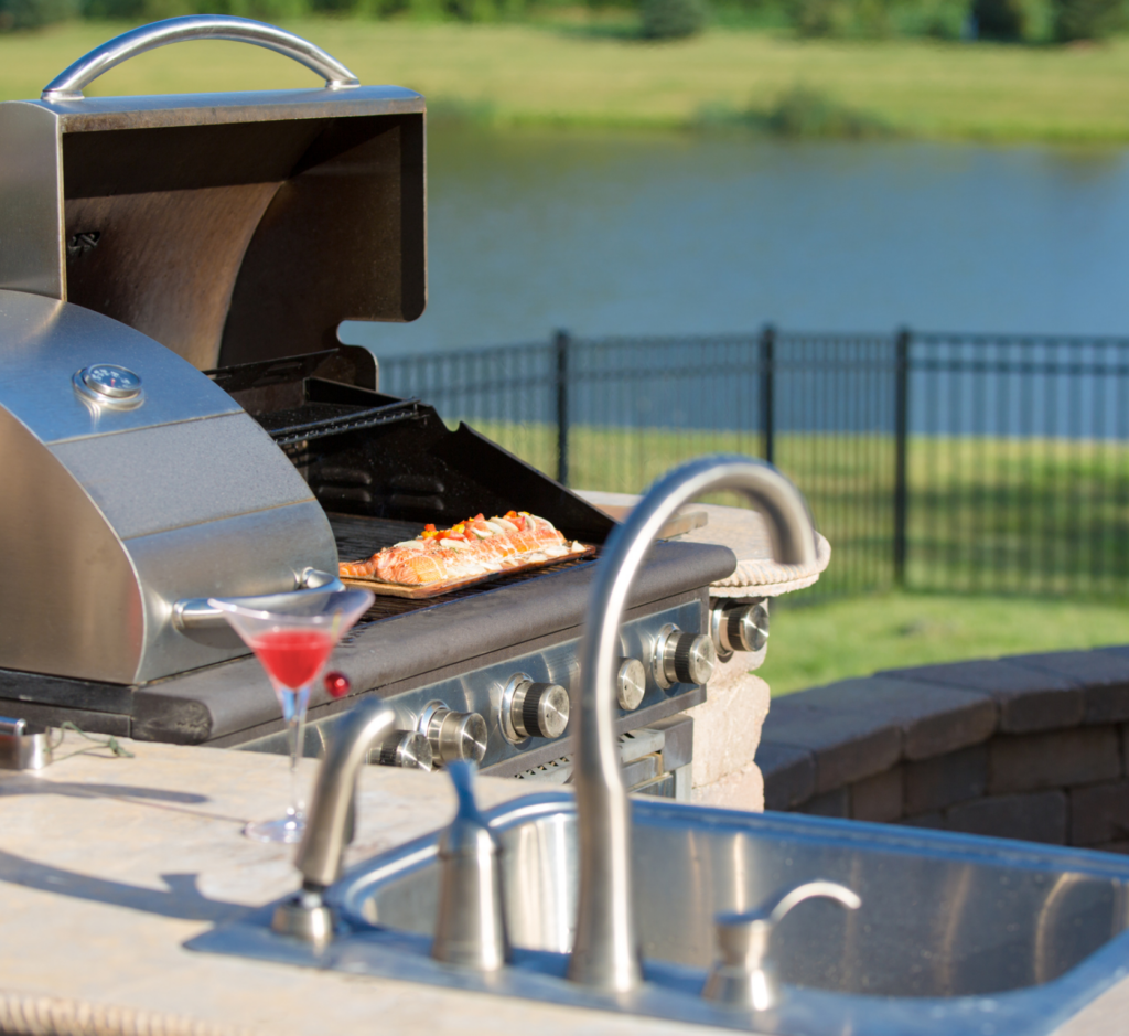 A stainless steel grill with a martini in front of it