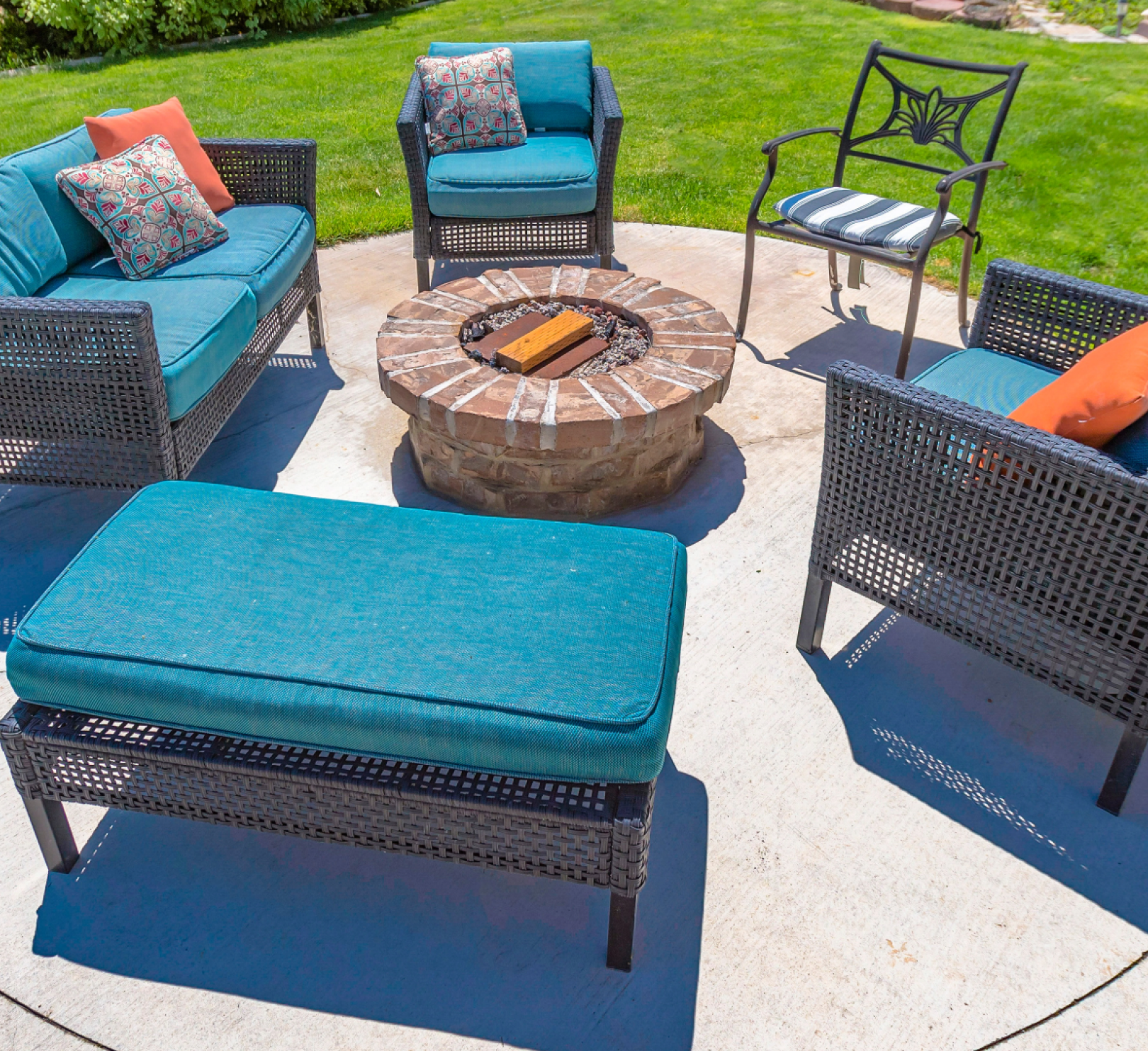 A patio set with a fire pit in the middle