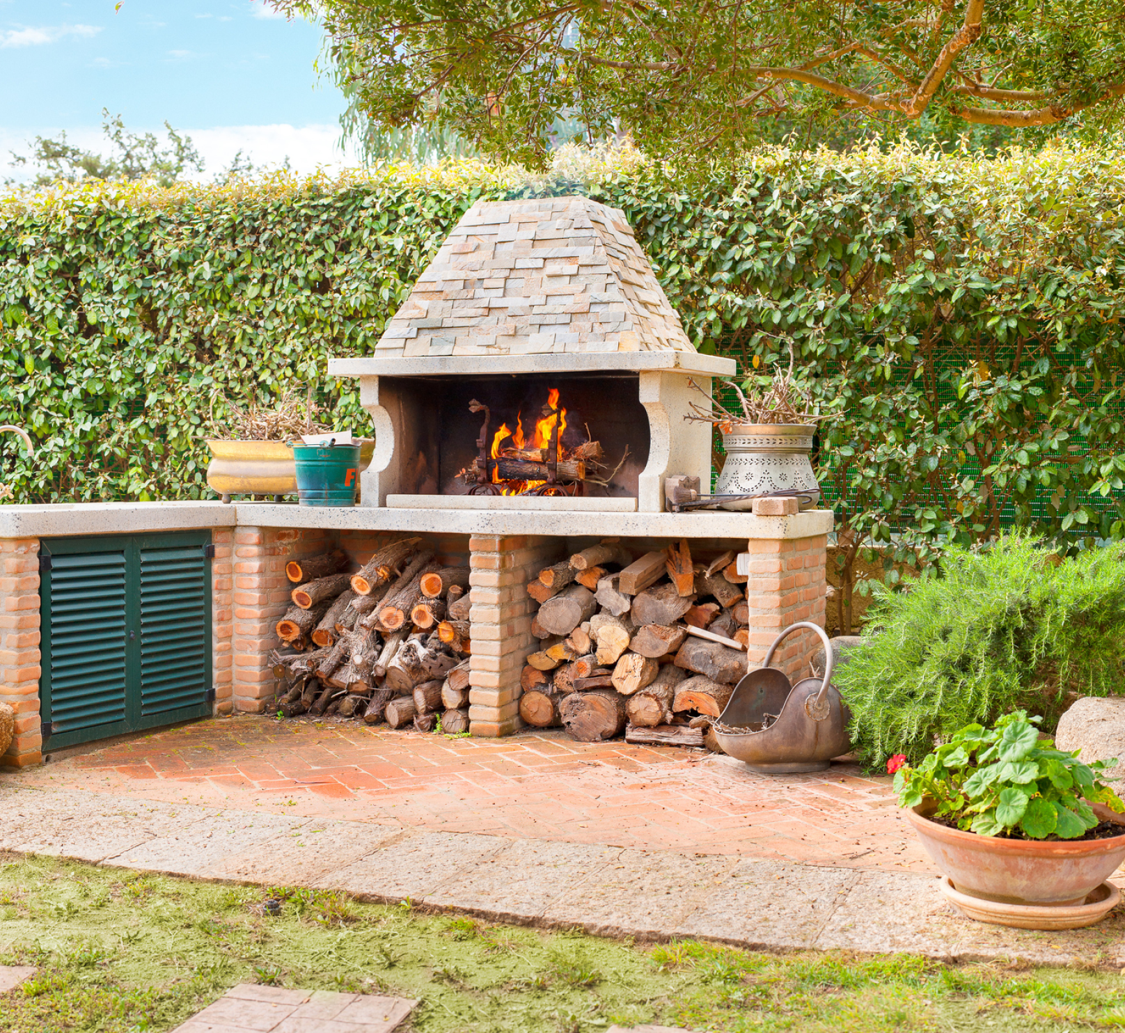 A brick fireplace with a pile of logs underneath it