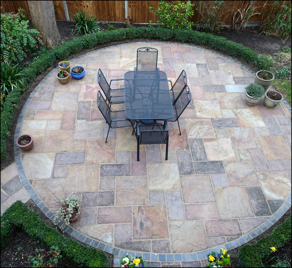 A patio with a table and chairs in a circle