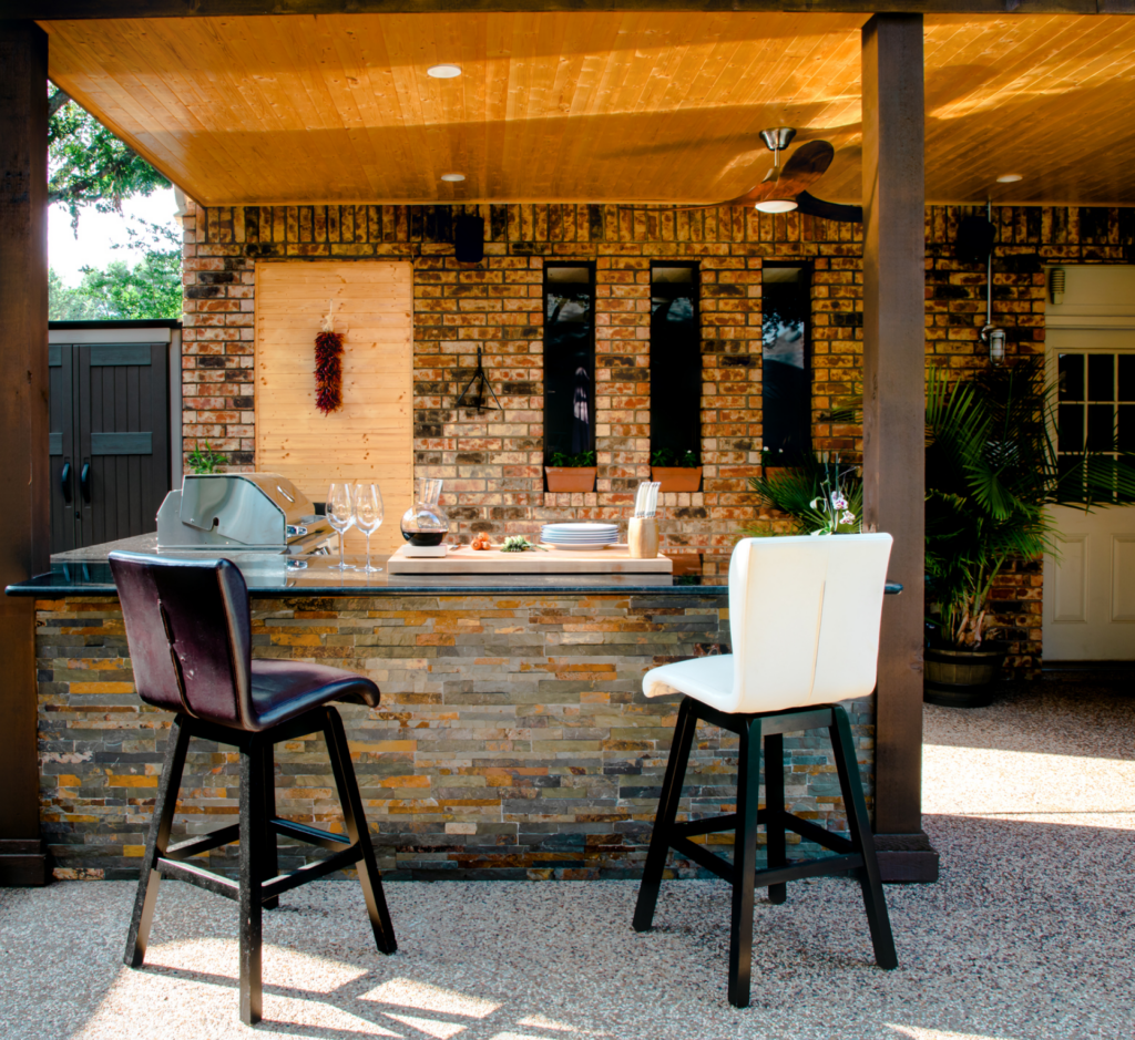 A brick building with a bar and two chairs