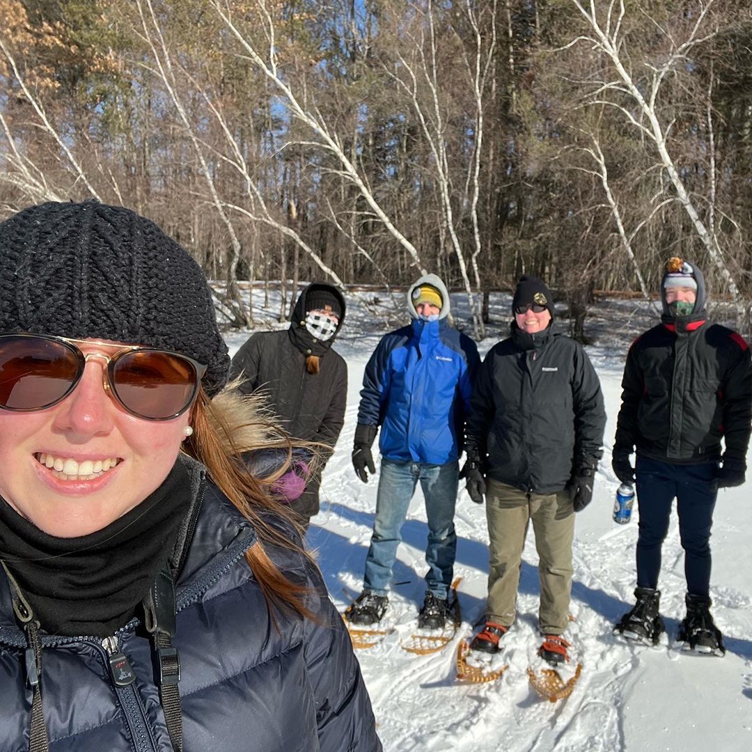Five individuals outside in winter. 