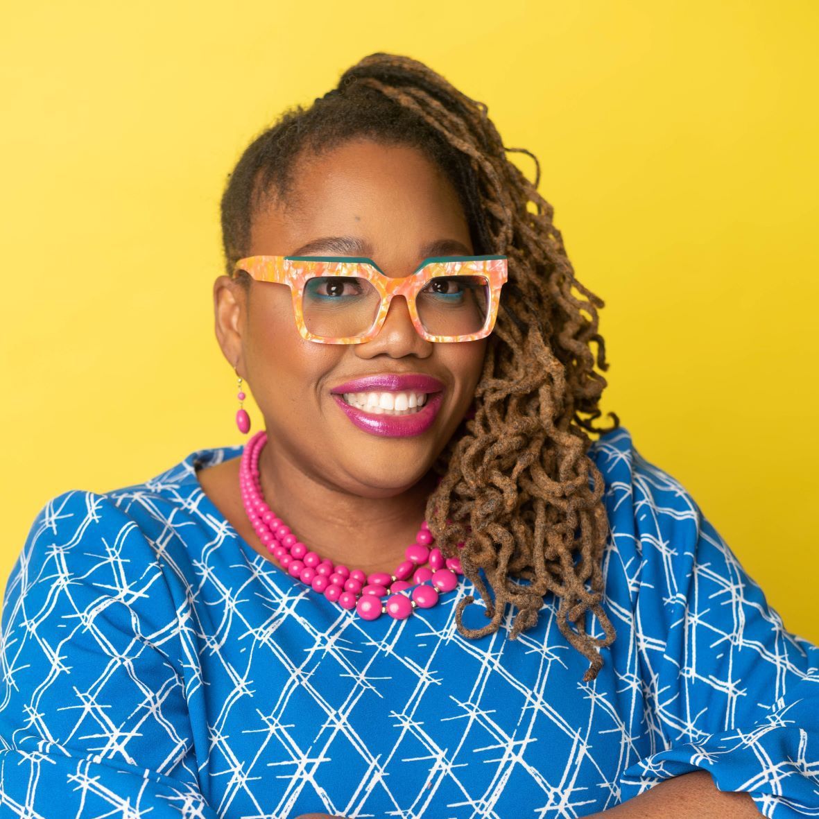 Woman in blue shirt against yellow background