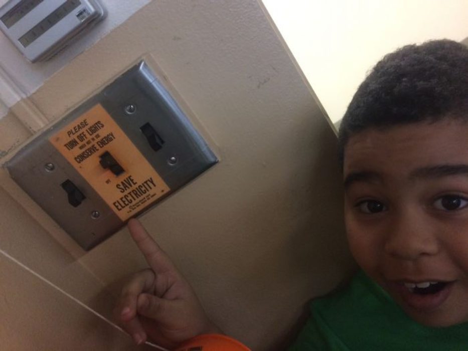 Boy pointing at light switch with a