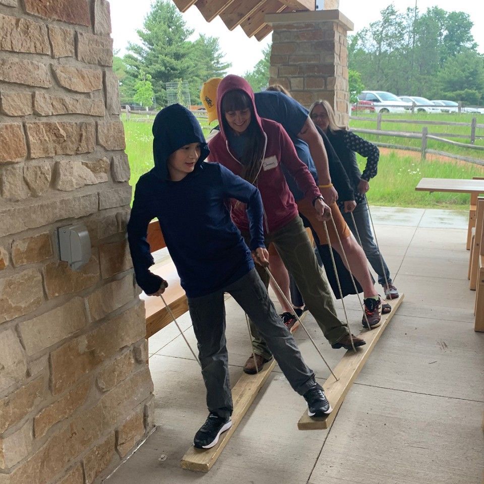 A group of people are standing on wooden skis