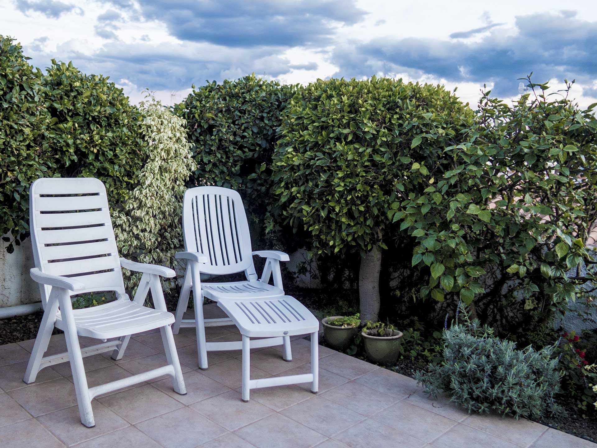 two comfortable plastic loungers in the beautiful garden