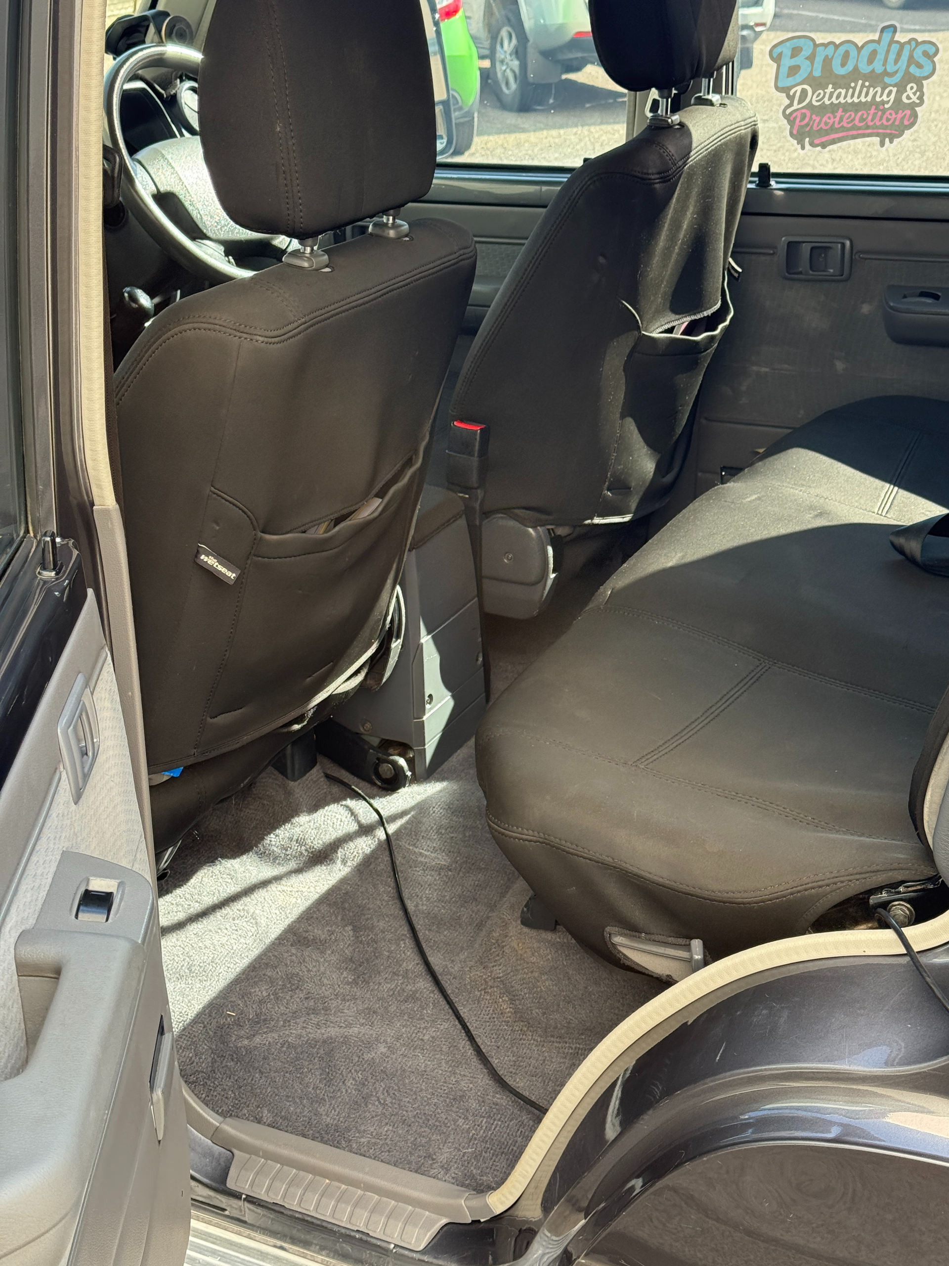 Interior of a Vehicle With Black Seat Covers, Grey Carpet — Brody’s Car Detailing In Tamworth, NSW