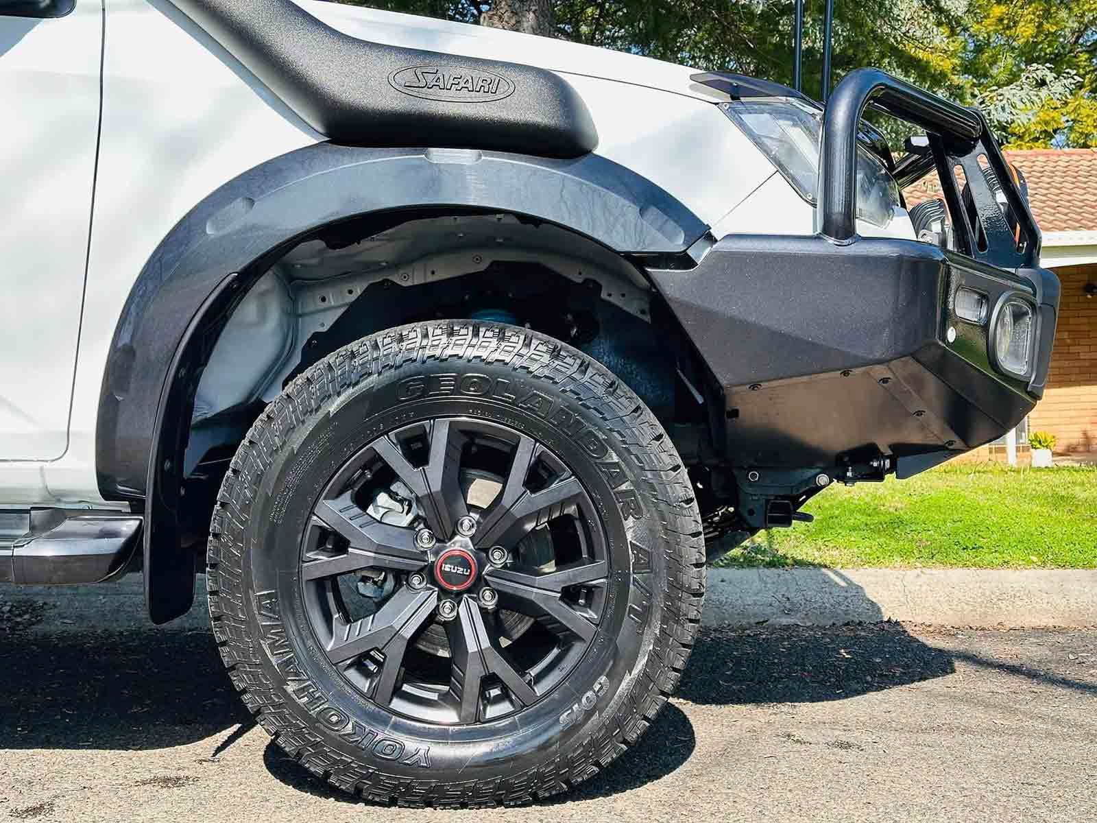 White truck with black tyres, bull bar, and snorkel on a street — Brody’s Car Detailing In Tamworth, NSW