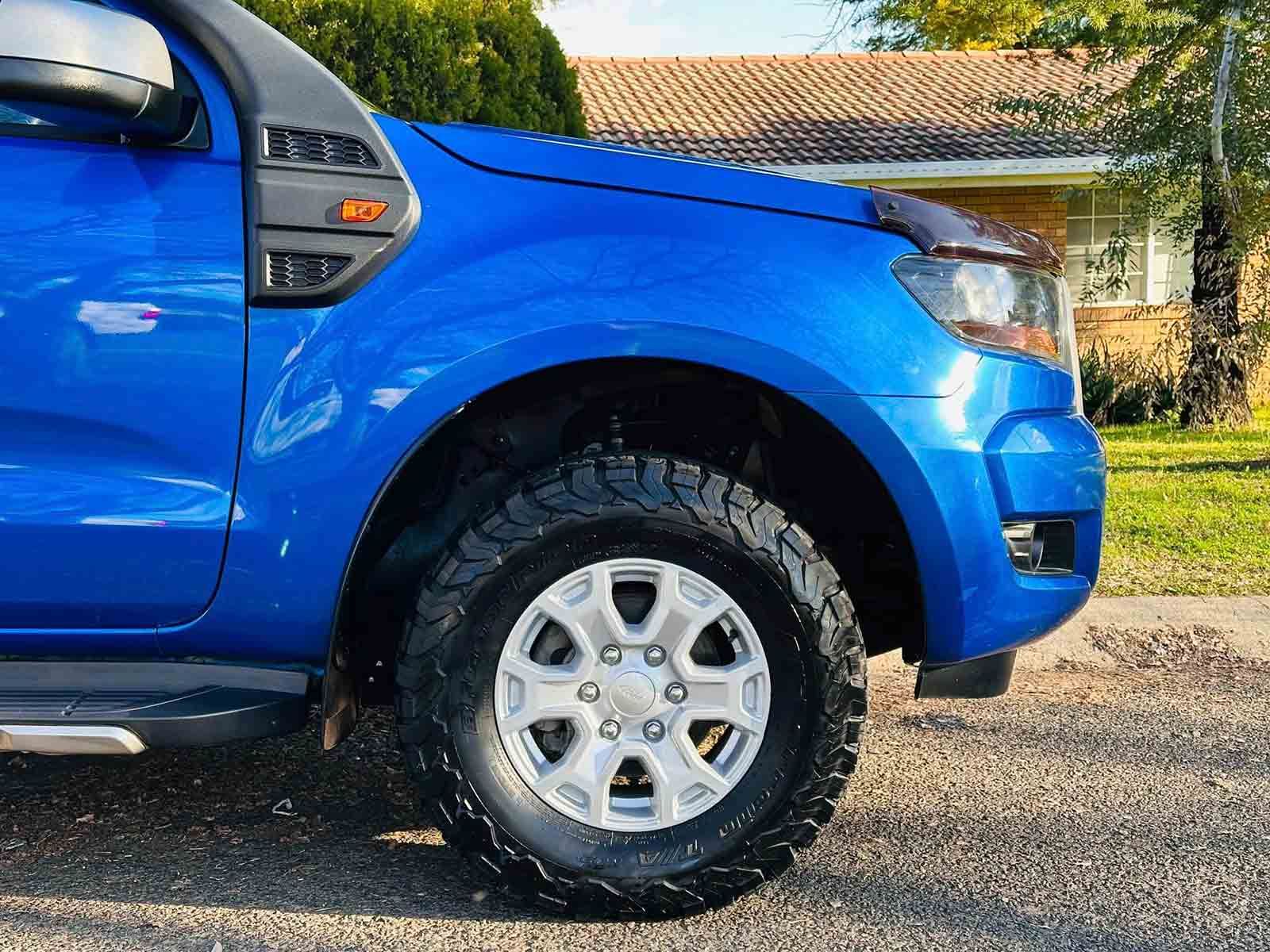 A Blue Truck Is Parked In Front Of A House — Brody’s Car Detailing In Tamworth, NSW