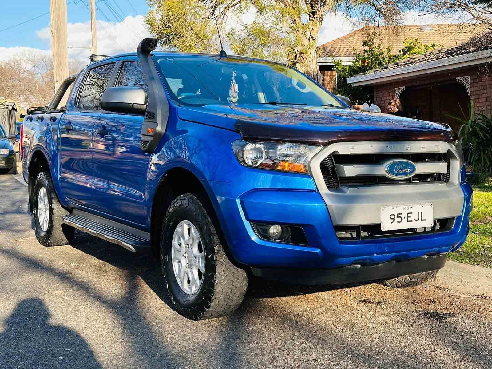 A Blue Ford Ranger Is Parked On The Side Of The Road — Brody’s Car Detailing In Tamworth, NSW