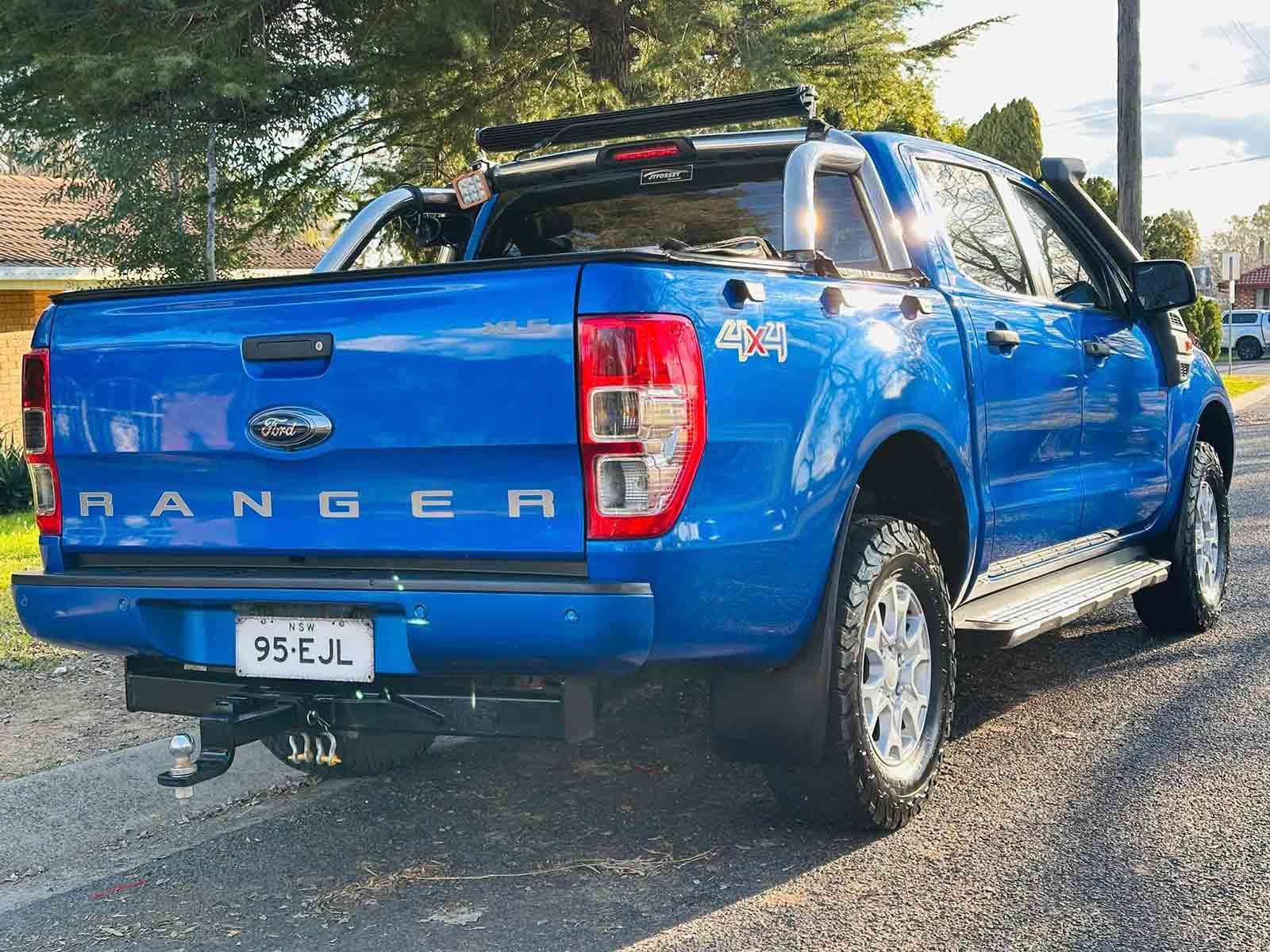A Blue Ford Ranger Is Parked On The Side Of The Road — Brody’s Car Detailing In Tamworth, NSW