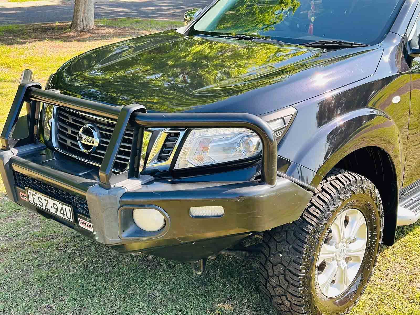 A Black Truck With A Black Bumper Is Parked In The Grass — Brody’s Car Detailing In Tamworth, NSW