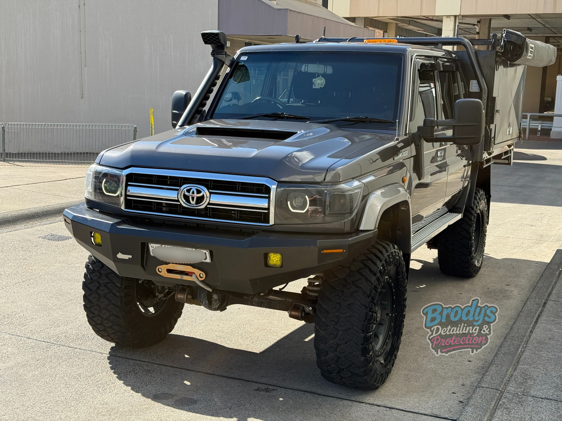 Dark grey Toyota Land Cruiser with off-road modifications, parked on a street. — Brody’s Car Detailing In Tamworth, NSW