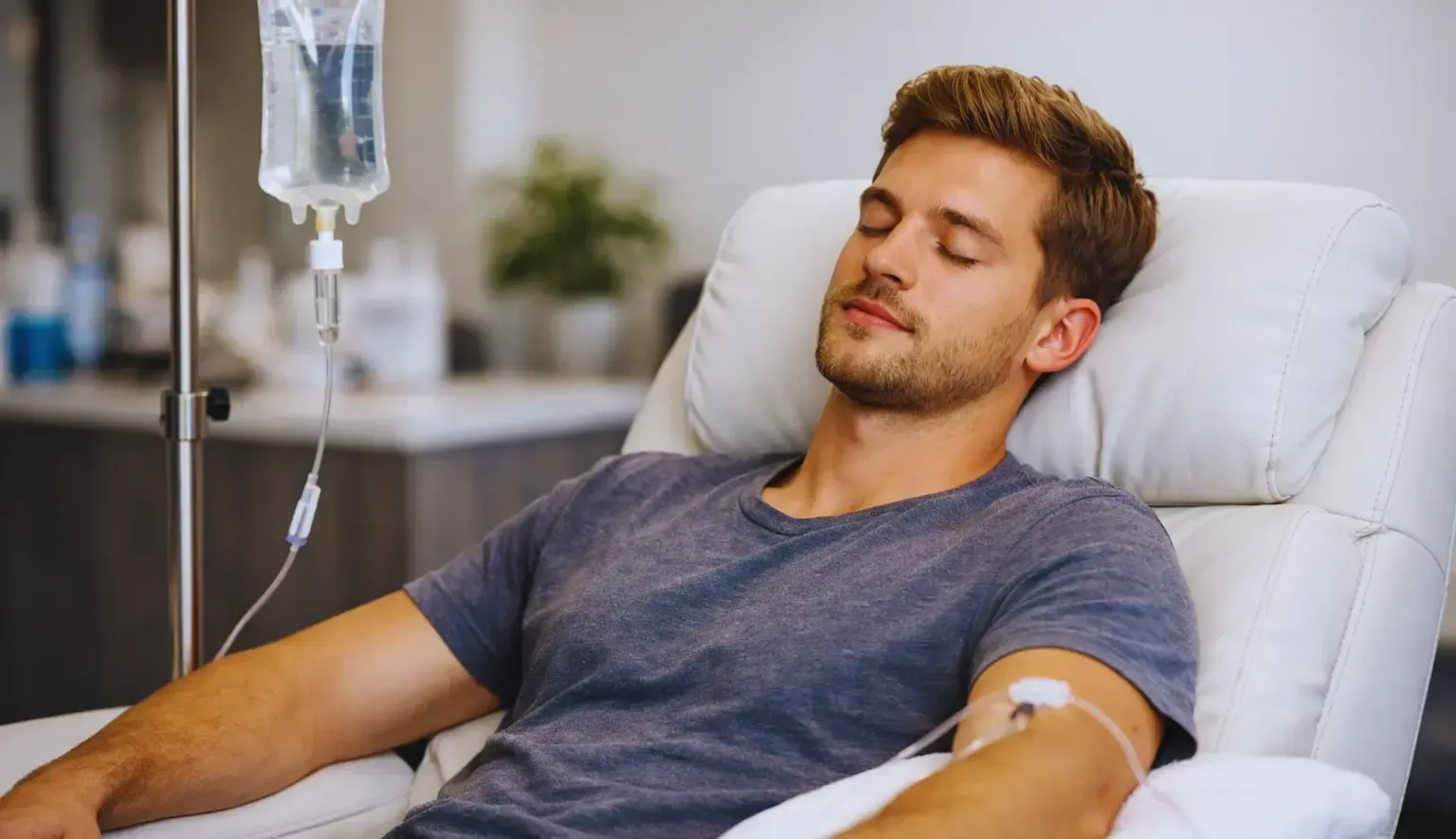 Patient resting in a clinic chair with an IV drip attached to his arm