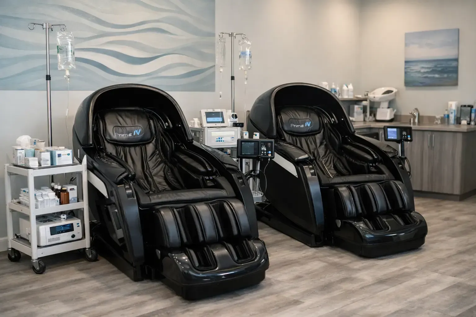 Spa room with two black massage chairs and rolling service carts in a bright, modern setting