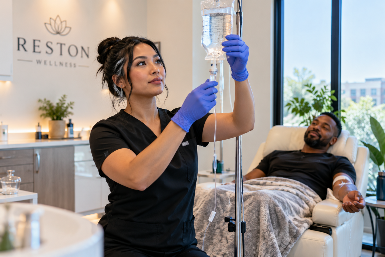 practitioner preparing a clear IV bag beside a reclining client in a bright Reston wellness suite