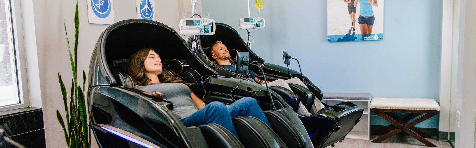 Clients relaxing in zero-gravity massage chairs during IV therapy at Prime IV Reston