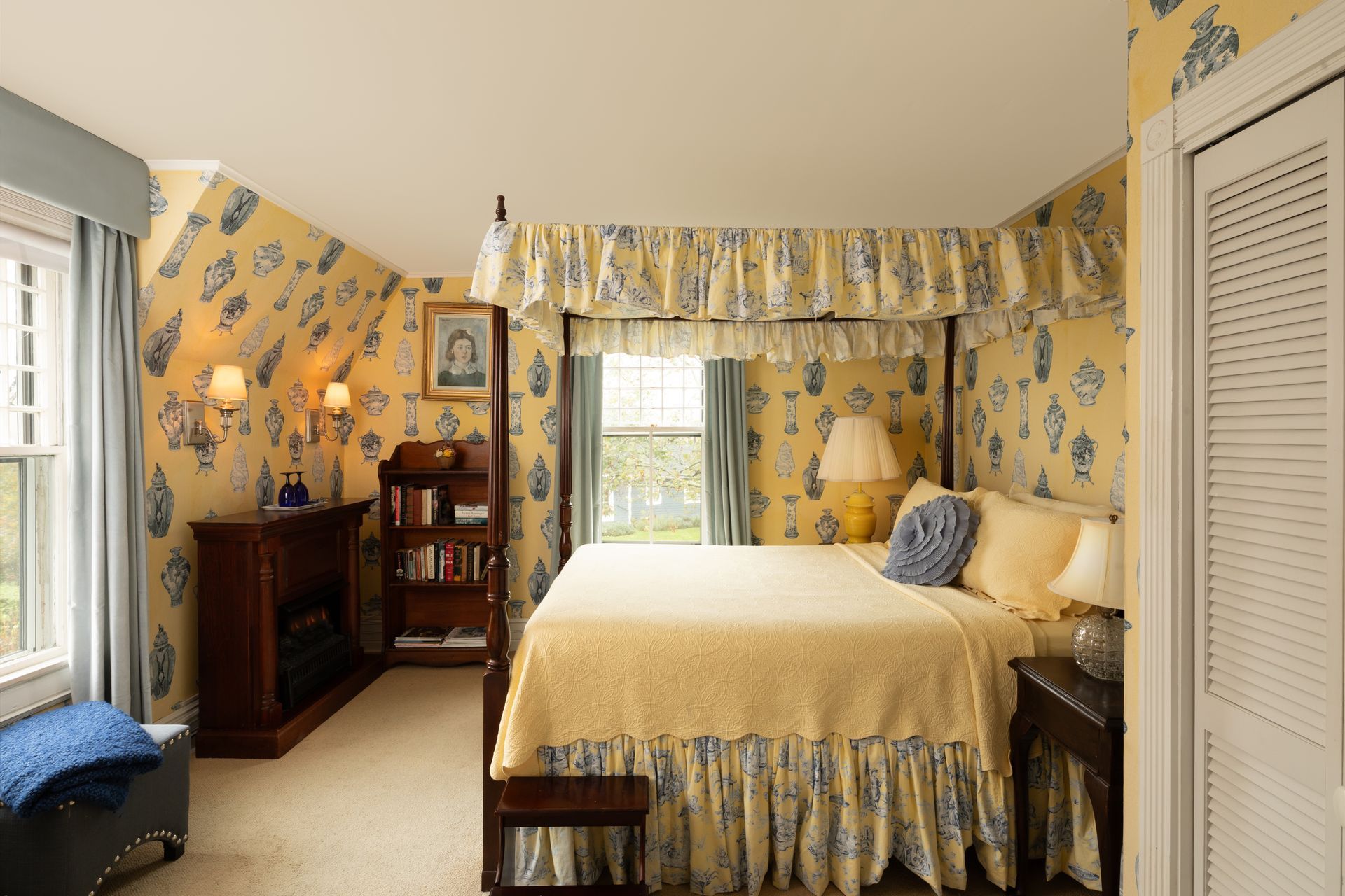 A bedroom with a canopy bed and a window
