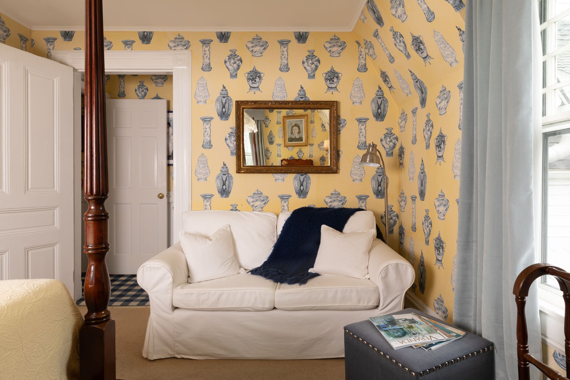 A living room with a four poster bed and a couch
