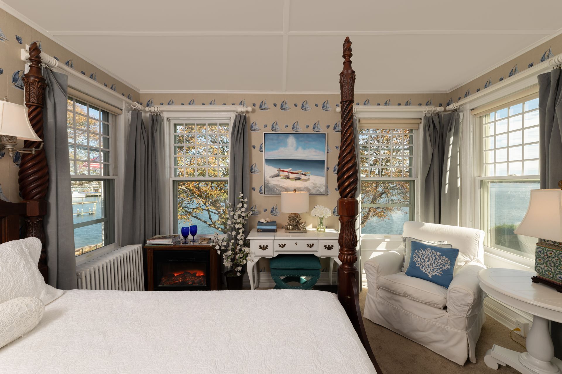 A bedroom with a four poster bed and a fireplace