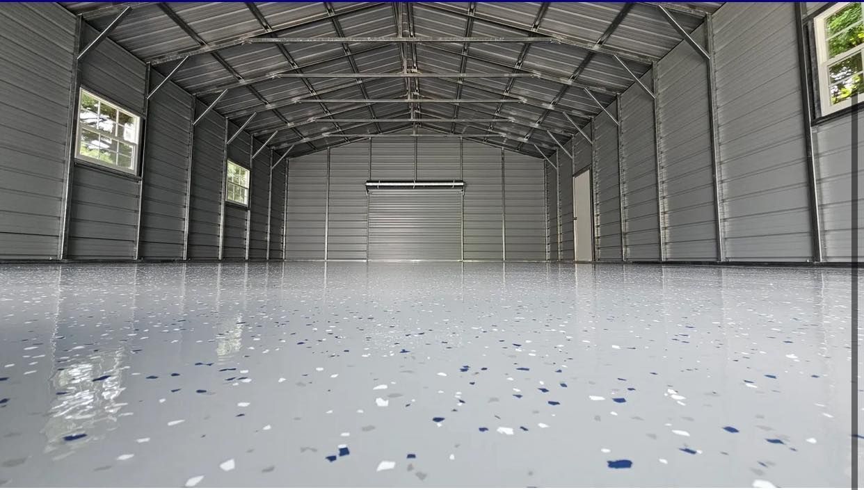 Empty hangar with a reflective white floor and scattered debris under a metal arched ceiling.
