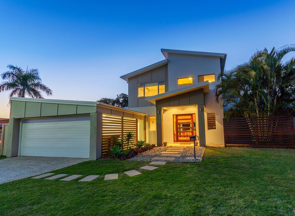 Modern Australian home front at dusk — Garage Door Repairs in Marcoola QLD