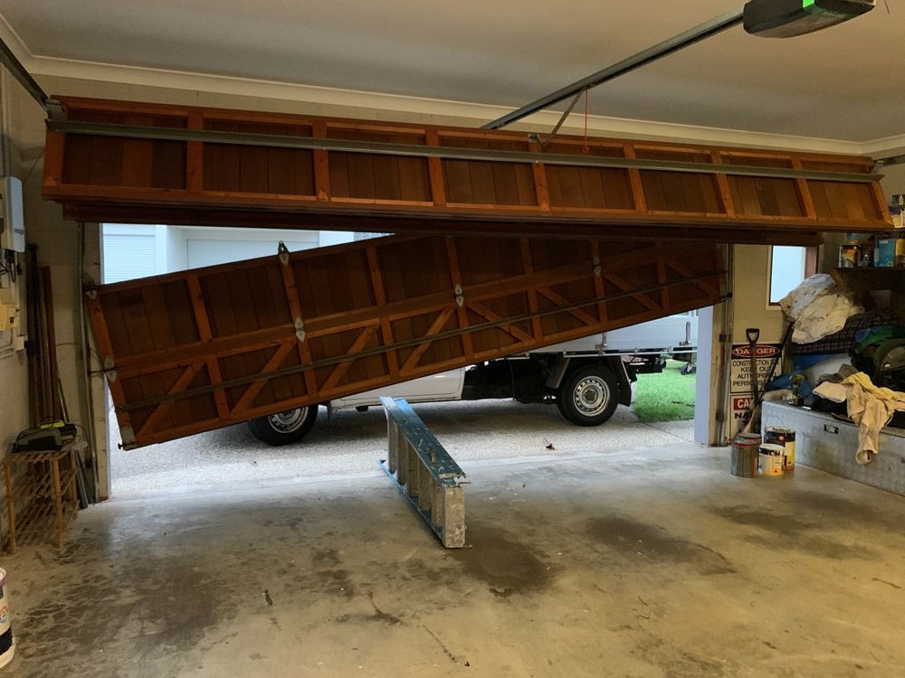 Broken Garage Door Before Image — Garage Door Repairs in Marcoola QLD