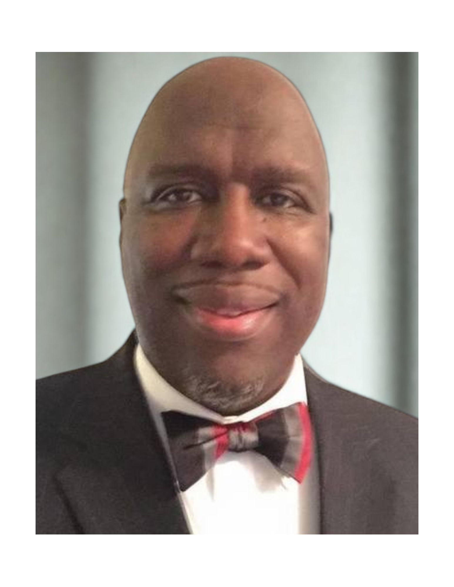 Man in suit and bow tie smiles at the camera.