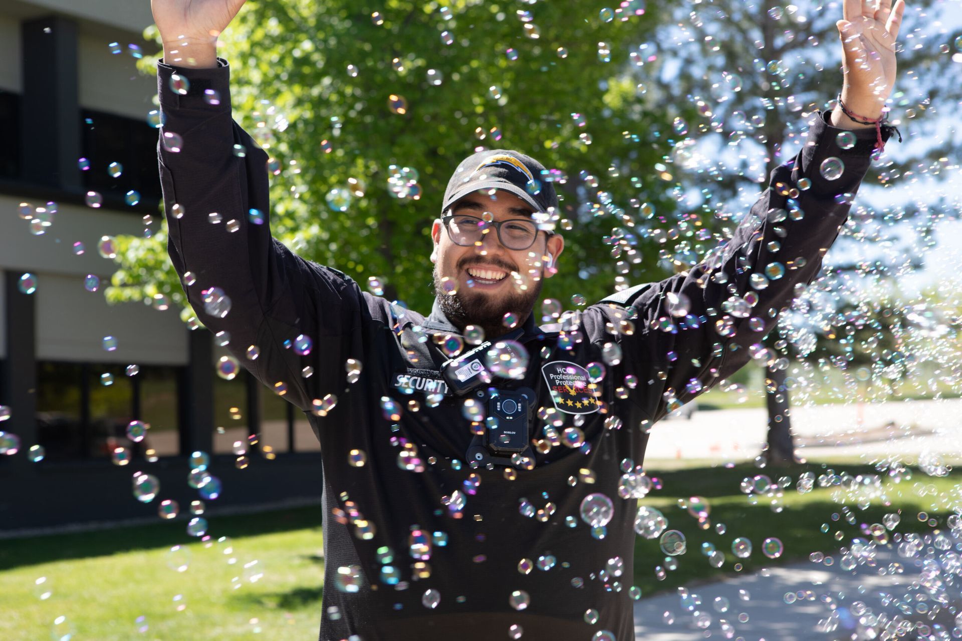 A man is standing in front of a bunch of soap bubbles.