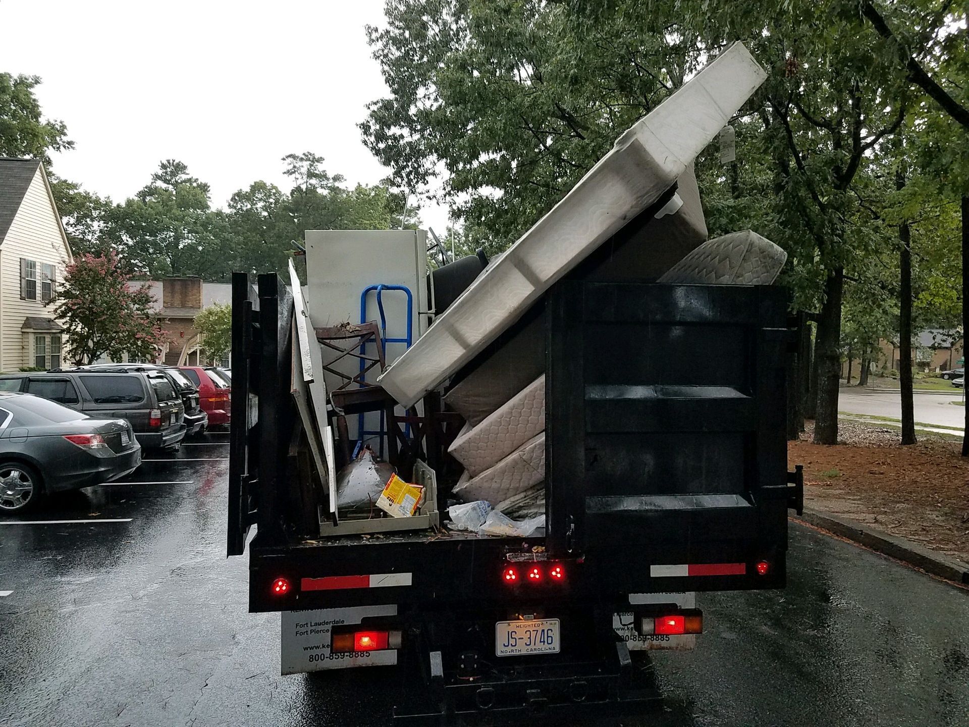 A dump truck is loaded with a lot of furniture