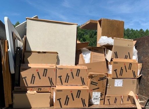 A pile of cardboard boxes are stacked on top of each other.