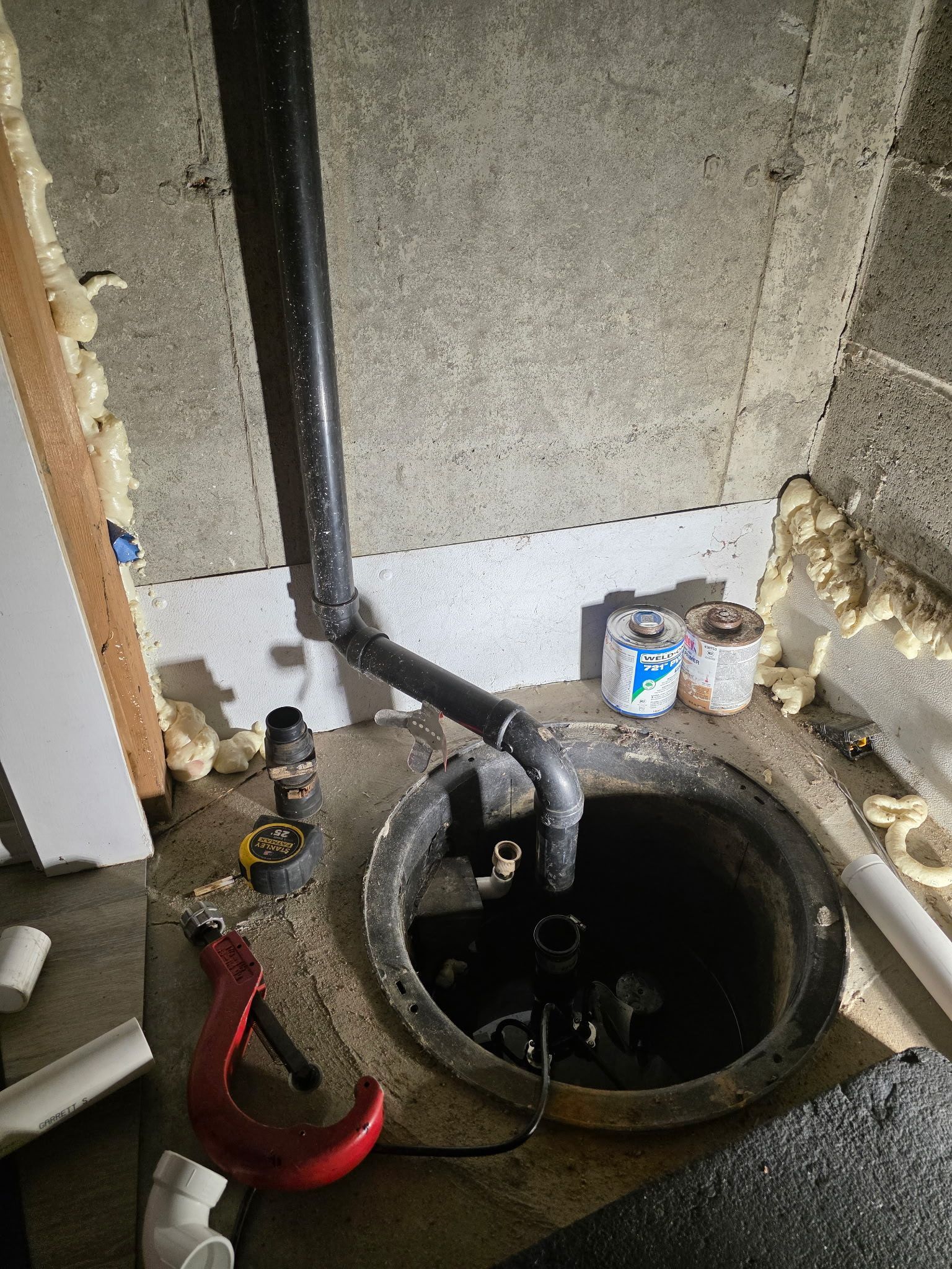 A sump pump being repaired by Bear Creek Plumbing because it flooded due to a handyman installing it incorrectly